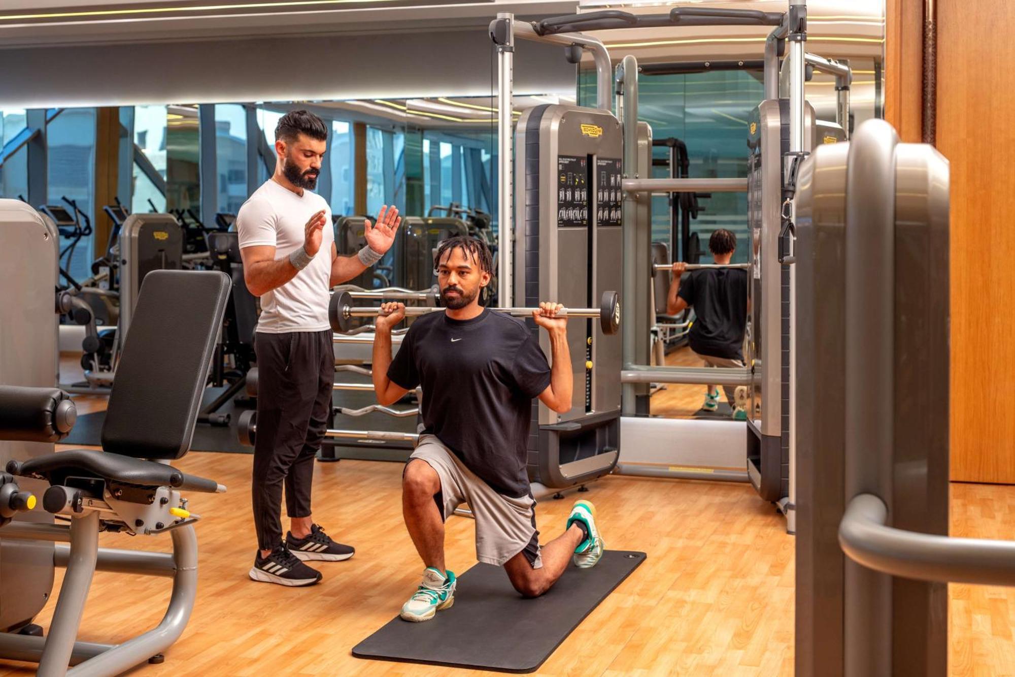 Hyatt Regency Riyadh Olaya Εξωτερικό φωτογραφία Personal trainer coaching a man on a Bulgarian split squat